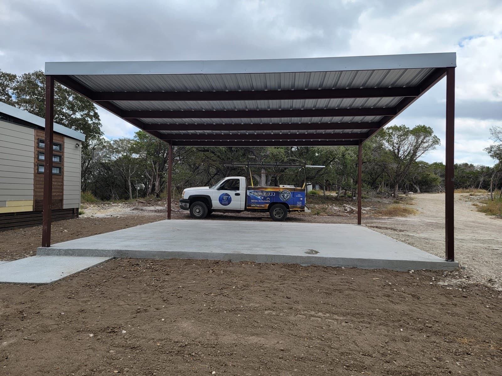 Finished Triple J carport with concrete pad — Central Texas install