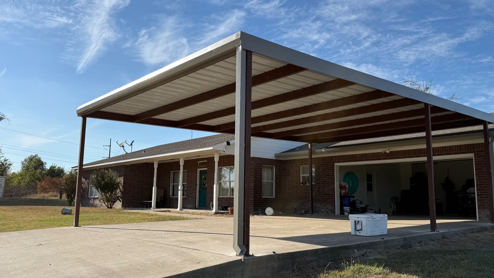 23×35 carport with gutters built by Triple J Metal in Rogers, Texas